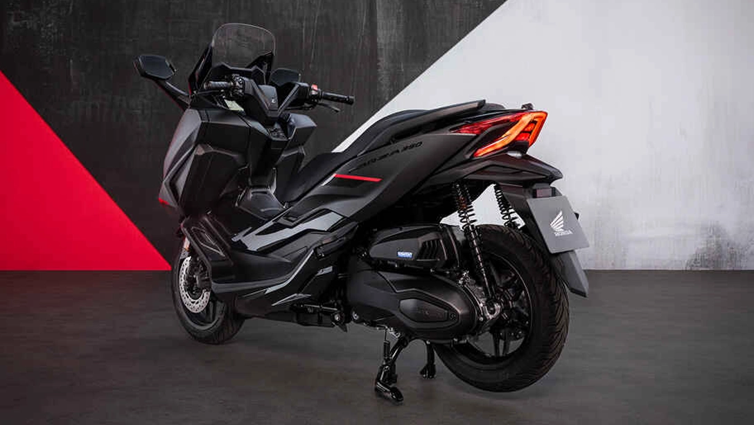 Vue latérale du Honda Forza 350 sur route, design moderne et dynamique